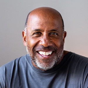 Closeup of man smiling in blue shirt