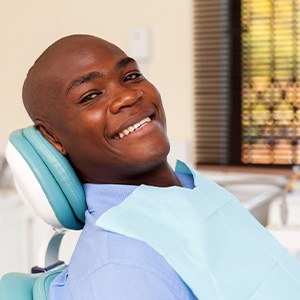 Smiling patient sitting in treatment chair