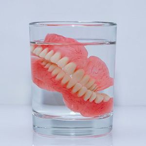 Dentures soak in clear liquid