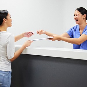 Jupiter patient talking to front desk about payment options