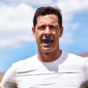 Man wears athletic mouthguard