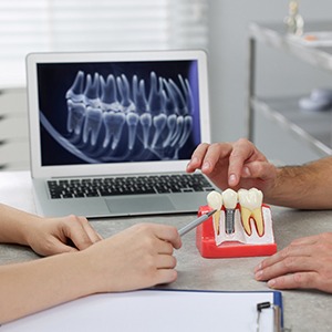 a dentist and patient talking about dental implants