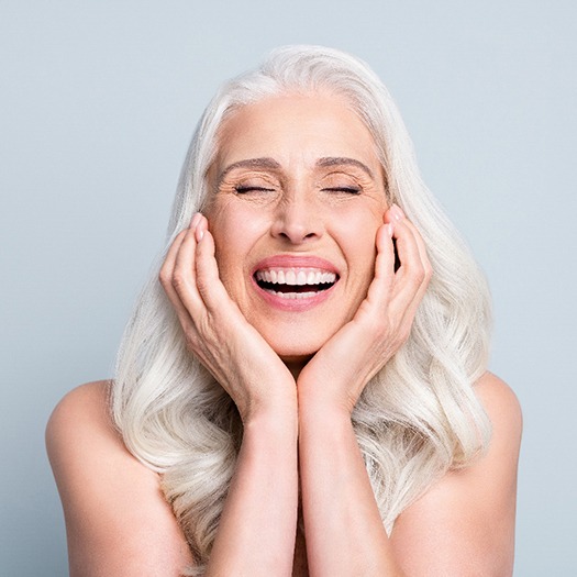 a dental implant patient showing off her smile