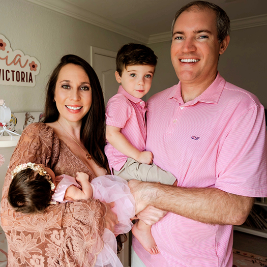 Doctor Rodriguez smiling with his wife and young child