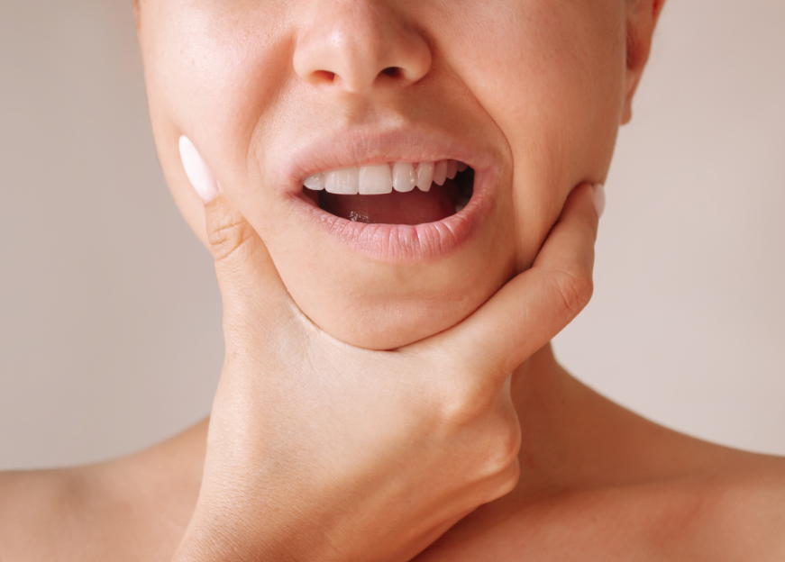 Close up of woman holding jaw, in pain