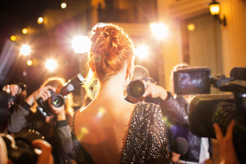 celebrity with dental implants getting photographed at premier